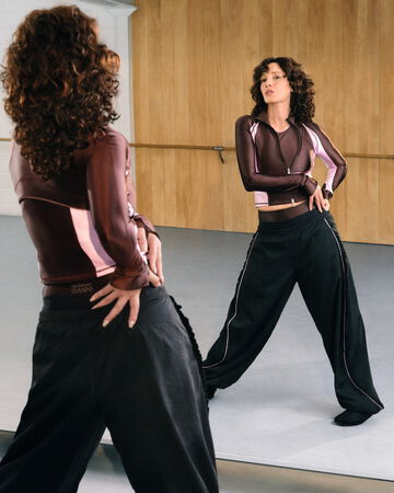 Model standing in front of mirror, wearing ECRIN x Lululemon set